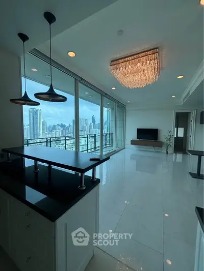 Luxurious high-rise apartment with stunning city view and elegant chandelier lighting.