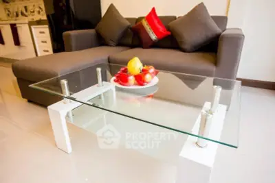 Modern living room with glass coffee table and stylish sofa, perfect for contemporary homes.