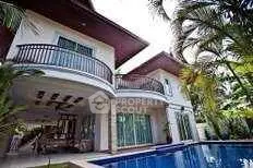 Luxurious tropical villa with pool and lush garden, perfect for serene living.