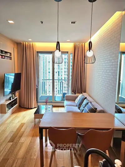 Modern living room with stylish decor and city view balcony.