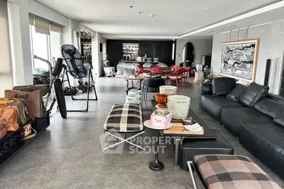 Spacious living room with modern decor and open layout, featuring stylish furniture and ample natural light.