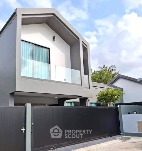 Modern two-story house with sleek design and glass balcony