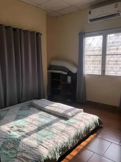Cozy bedroom with natural light, air conditioning, and modern decor.