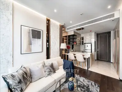 Luxurious modern living room with open kitchen, elegant decor, and stylish furniture in a contemporary apartment.