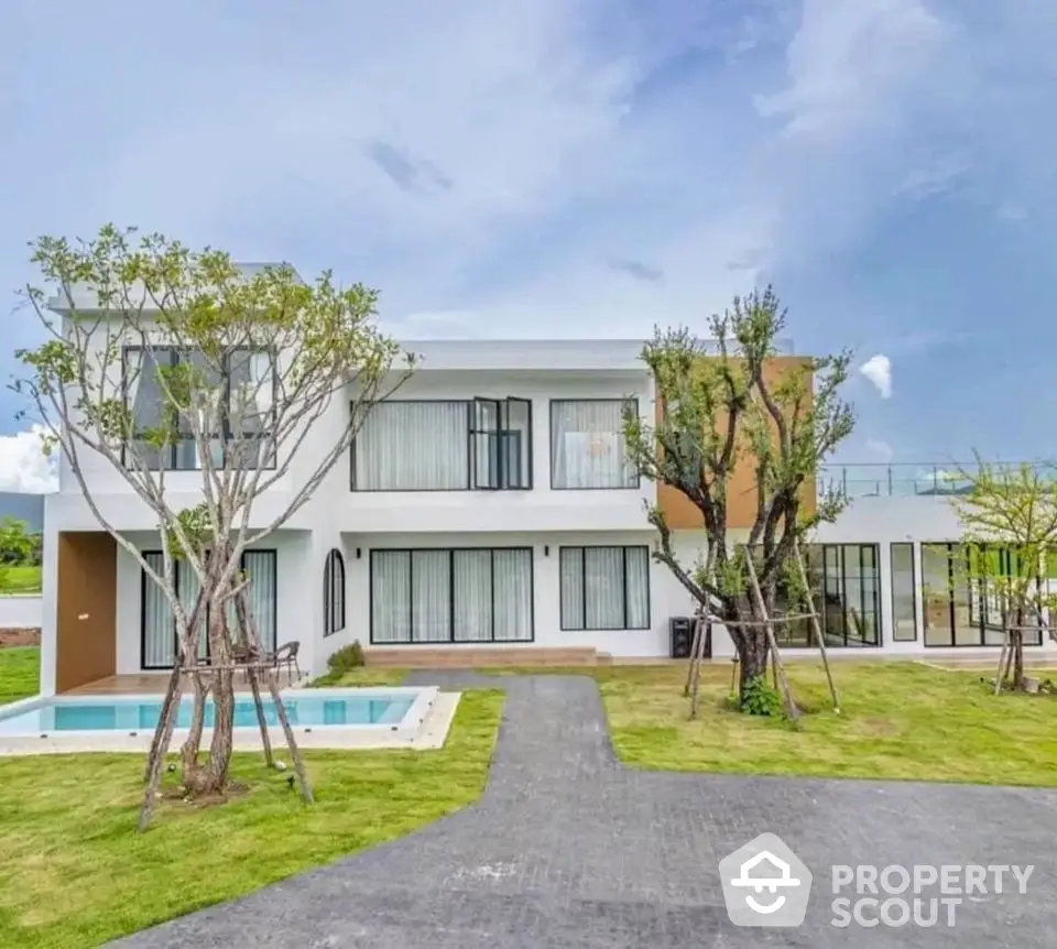 Modern two-story house with pool and landscaped garden