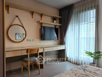 Modern bedroom with stylish decor, wall-mounted TV, and large window with sheer curtains.