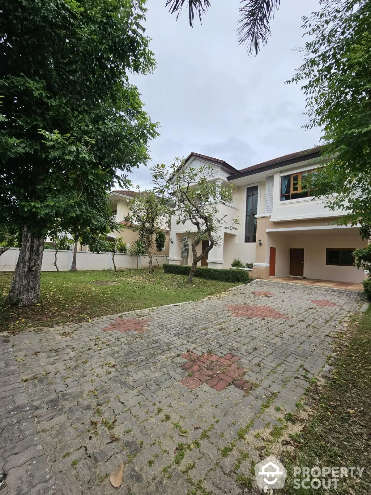 Stunning two-story home with lush garden and spacious driveway