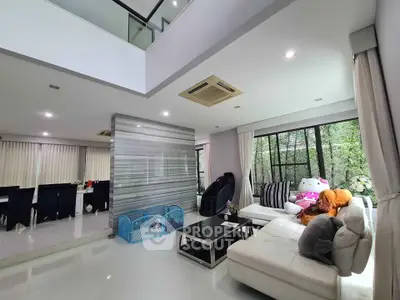 Spacious modern living room with large windows and stylish decor