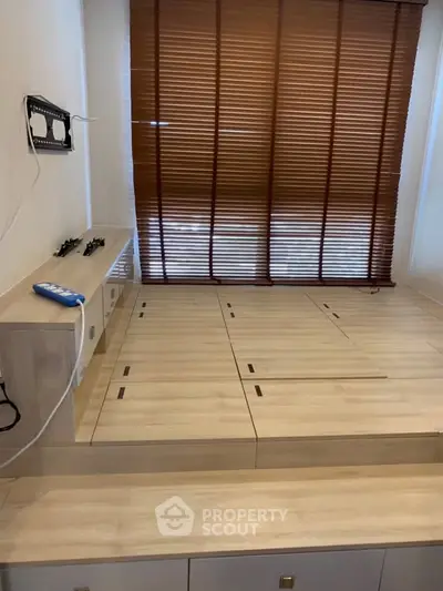 Modern minimalist bedroom with wooden platform and blinds