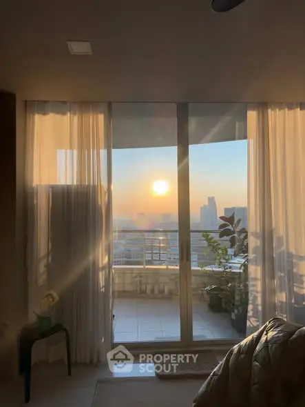 Stunning sunset view from modern apartment balcony with city skyline.