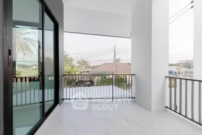 Spacious balcony with modern railing and scenic neighborhood view