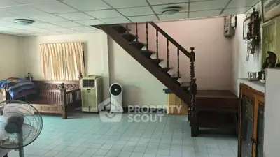 Spacious living room with staircase and traditional wooden furniture