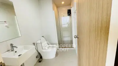 Modern bathroom with sleek fixtures and glass shower enclosure