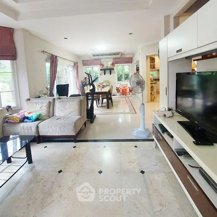 Spacious living room with modern decor and large windows for natural light.