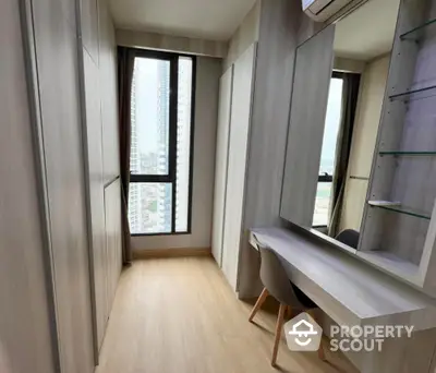 Modern study room with built-in desk and city view in high-rise apartment.