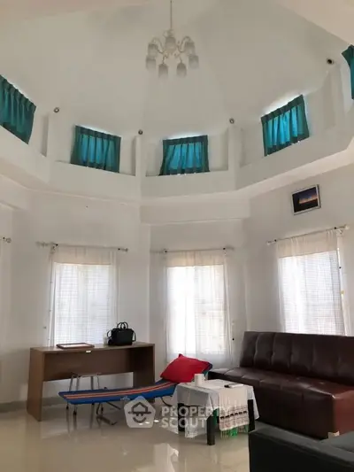 Spacious living room with high ceiling and elegant decor