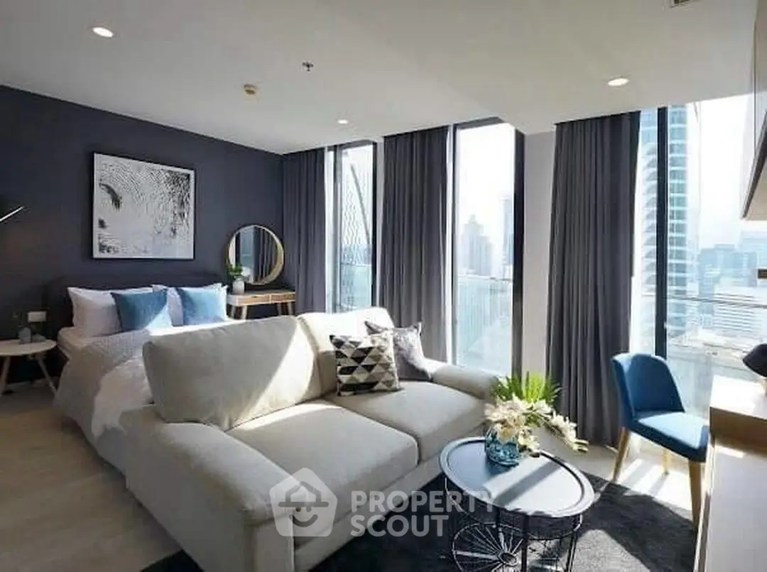 Luxurious modern living room with stunning city view, elegant decor, and ample natural light in high-rise apartment.