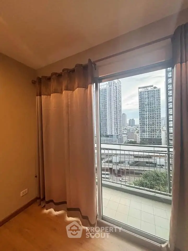 Spacious apartment with balcony offering stunning city views in modern high-rise building.