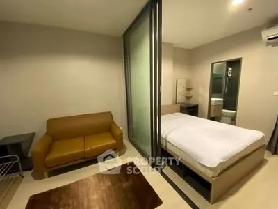 Modern studio apartment with cozy bed and stylish sofa