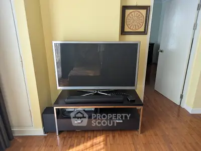 Cozy living room with modern TV setup and wooden flooring