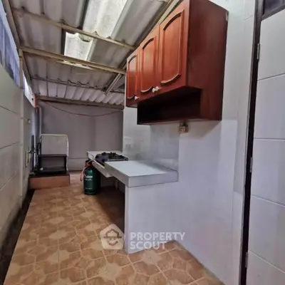 Spacious kitchen with gas stove and ample storage in a modern home.