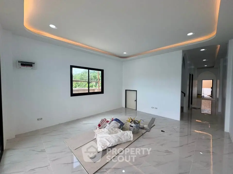 Spacious modern living room with elegant lighting and large window