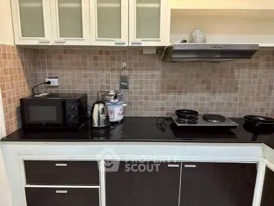 Modern kitchen with sleek appliances and stylish cabinetry, perfect for culinary enthusiasts.