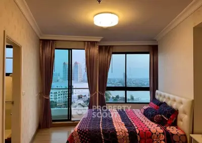 Spacious bedroom with stunning city view and elegant decor