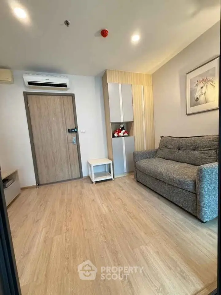 Cozy living room with modern sofa and air conditioning in a stylish apartment.