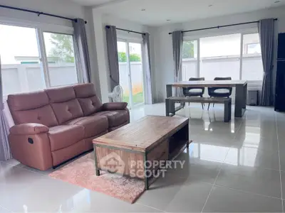 Spacious living room with modern furniture and large windows for natural light.