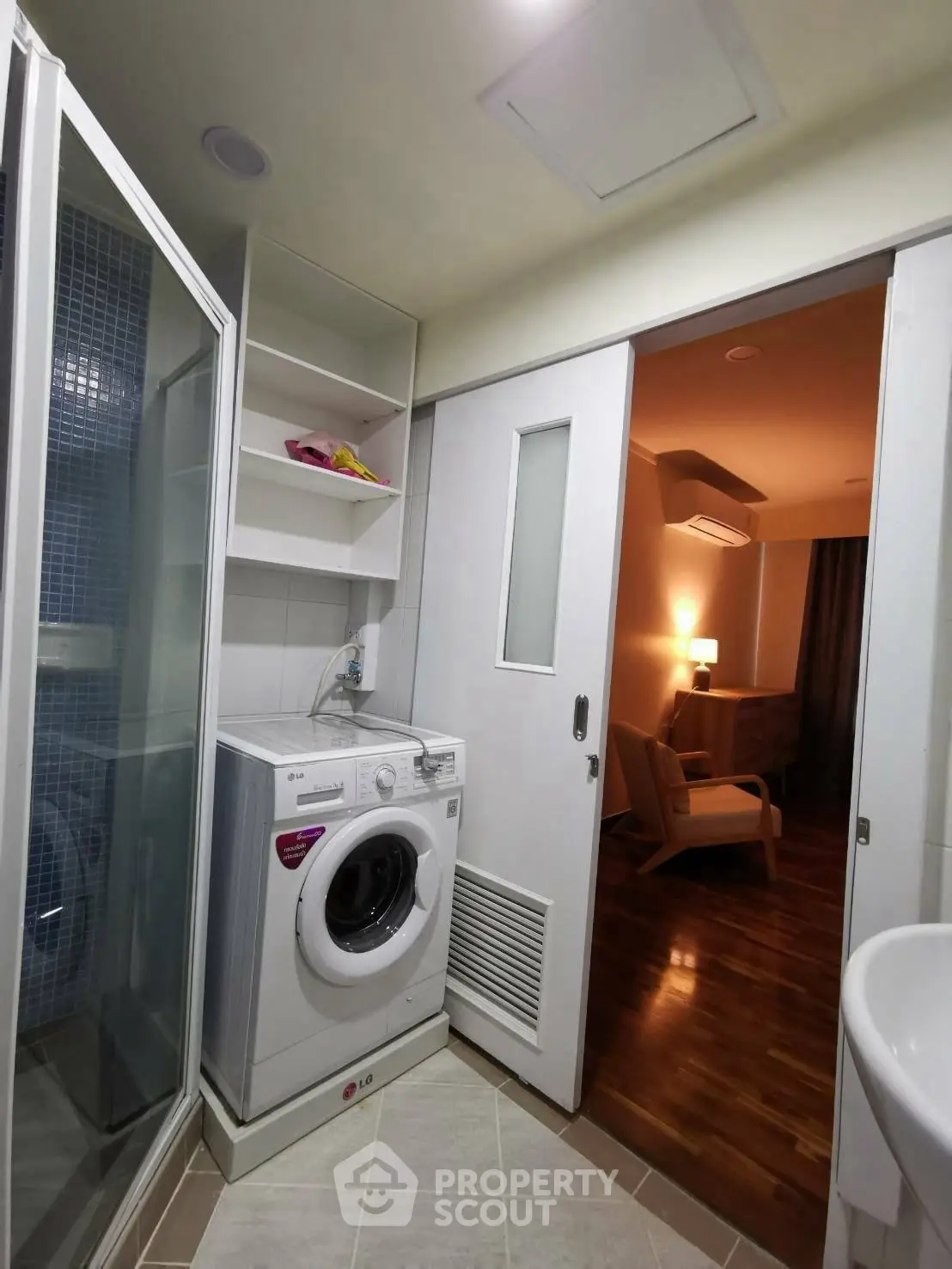 Modern bathroom with washing machine and shower in compact space