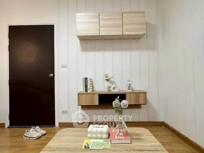 Modern living room with minimalist wooden furniture and decor accents.