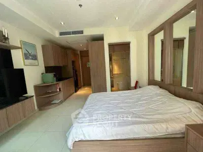 Spacious bedroom with modern wooden furnishings and cozy ambiance