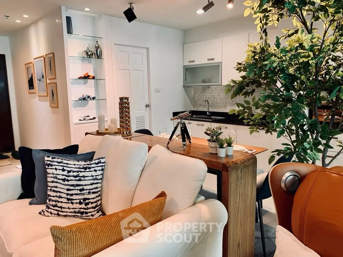 Modern open-layout living room with stylish kitchen and cozy seating area.