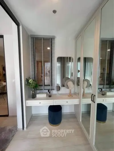 Elegant bedroom corner with mirrored wardrobe and stylish vanity setup