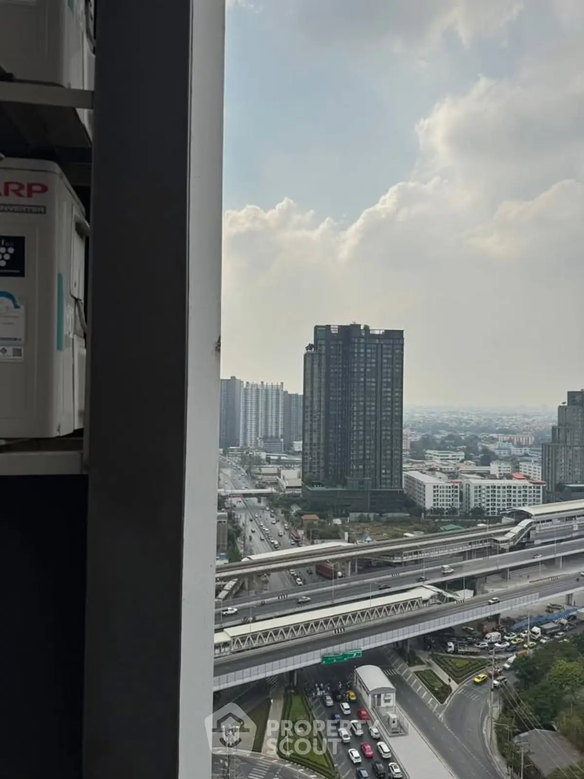 Stunning urban view from high-rise building overlooking cityscape and highways.