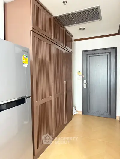 Modern kitchen with sleek fridge and ample storage cabinets