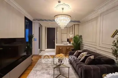 Luxurious living room with elegant chandelier and plush sofa