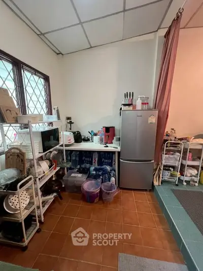 Cozy kitchen with fridge and ample storage space, perfect for culinary enthusiasts.