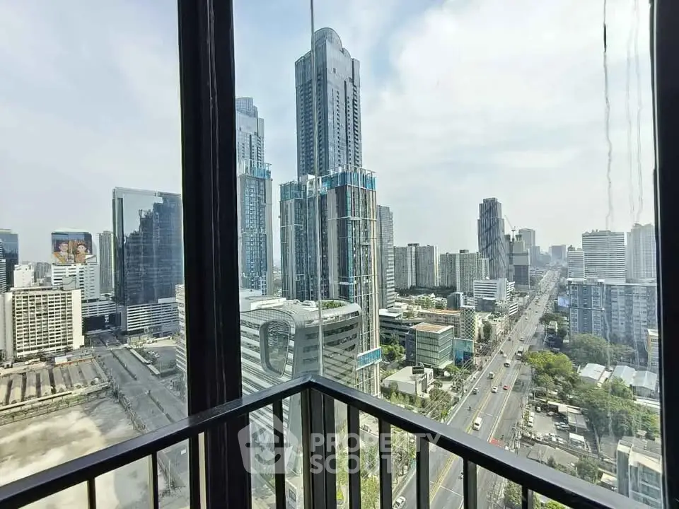 Stunning cityscape view from a high-rise balcony showcasing modern skyscrapers and bustling streets.