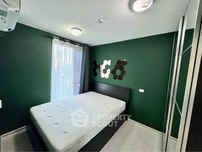 Modern bedroom with dark green walls and stylish decor