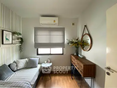 Cozy and stylish small living room with modern decor and natural light.