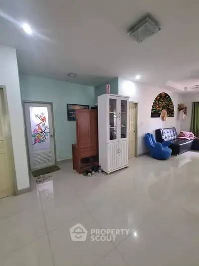 Spacious living room with modern decor and ample natural light