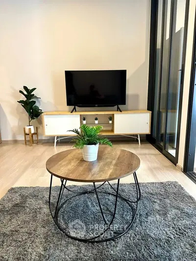 Modern living room with stylish furniture and TV setup, perfect for relaxation.