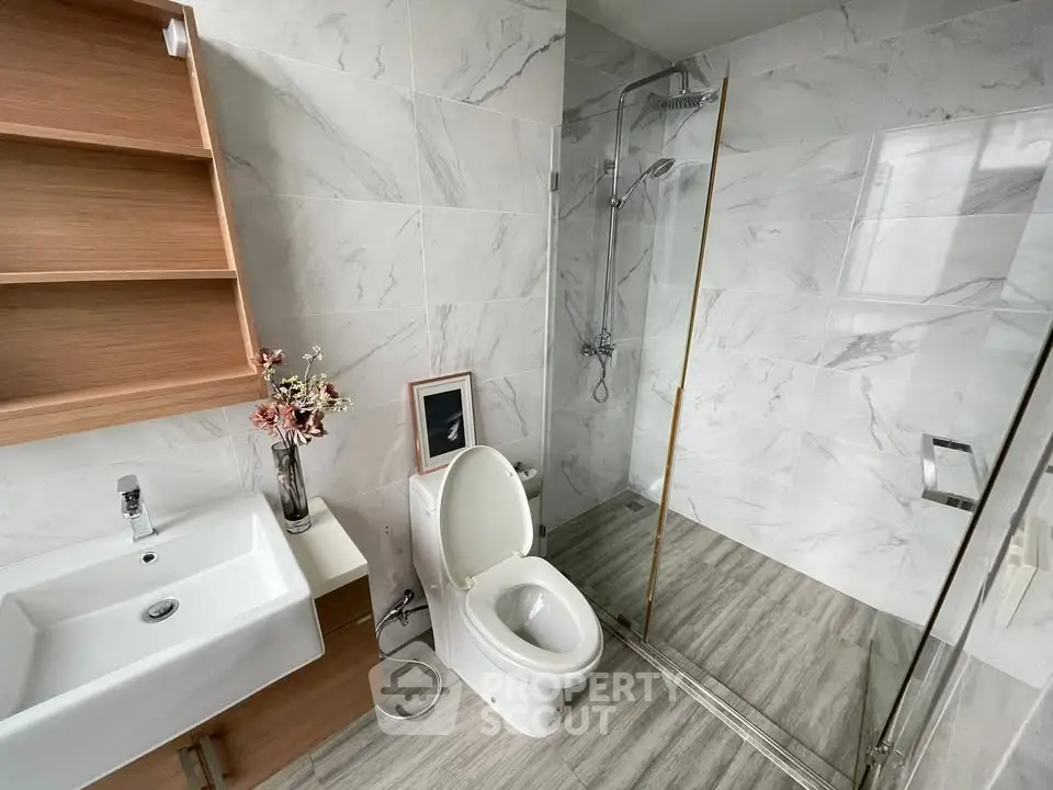 Modern bathroom with glass shower and elegant fixtures