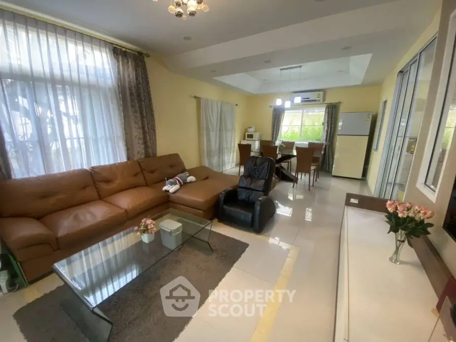 Spacious living room with modern furniture and open dining area