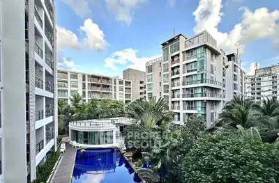 Luxurious modern apartment complex with pool and lush greenery