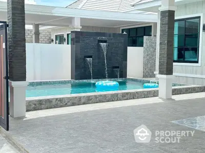 Luxurious modern home with private pool and elegant water features, perfect for relaxation and entertainment.