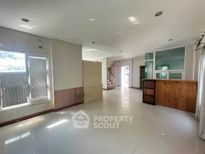Spacious open-plan living area with natural light and modern design.