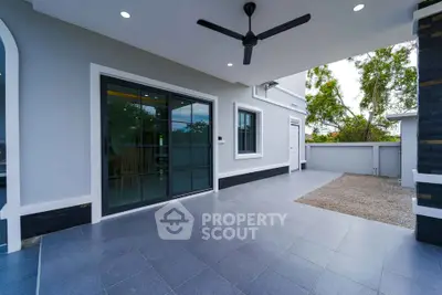 Spacious modern patio with sliding glass doors and ceiling fan